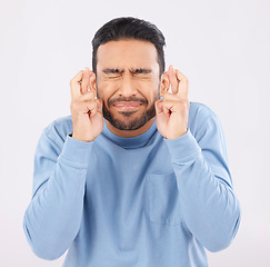 Image showing Hope, fingers crossed and asian man in studio with good luck sign for bonus, prize or giveaway on grey background. Eyes closed, wish and Japanese male with emoji for waiting, reward or lotto results