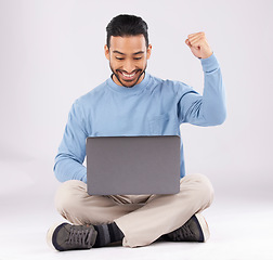 Image showing Happy, yes and success with man and laptop in studio for deal, winner and good news. Technology, internet and achievement with person and fist pump on white background for website, wow or celebration