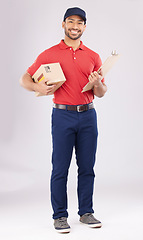 Image showing Asian man, portrait and box with clipboard in delivery, signature or checklist against a grey studio background. Male person smile in supply chain, logistics or courier service with parcel or package