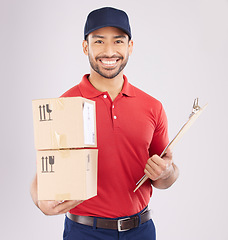 Image showing Happy asian man, portrait and box for courier service, delivery and clipboard for checklist against a grey studio background. Male person smile in supply chain with parcel or package for logistics