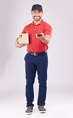 Image showing Asian man, portrait and box with pos for payment, delivery or ecommerce against a grey studio background. Male person smile in supply chain, logistics or courier service with package and card machine