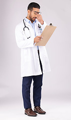 Image showing Tired man, doctor and headache with clipboard in burnout, stress or overworked against a grey studio background. Medical or healthcare male person with head pain, mental health or bad clinic results