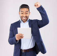 Image showing Happy businessman, tablet and fist pump in celebration for winning, promotion or bonus against a grey studio background. Excited asian man on technology for good news, lottery prize or sale discount