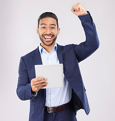 Image showing Happy businessman, portrait and tablet with fist pump in celebration for promotion win against a grey studio background. Excited asian man on technology for good news, lottery prize or sale discount