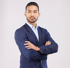 Image showing Business man, arms crossed and studio portrait with serious face, ambition or mindset by white background. Asian entrepreneur, financial advisor and suit for corporate fashion with professional style