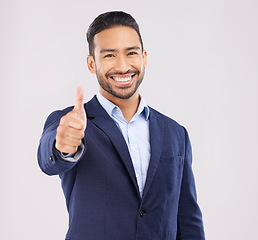 Image showing Happy businessman, portrait and thumbs up for success, approval or winning against a grey studio background. Asian man smile with like emoji, yes sign or good job for business agreement and thank you