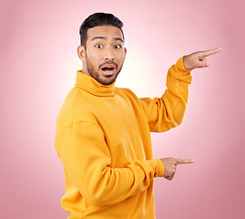 Image showing Surprise, pointing and wow with portrait of man in studio for show, announcement and deal. News, advertising and idea with person on pink background for promotion, information and solution mockup