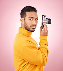 Image showing Portrait, man with a camera and creative photography or taking a picture for art, travel or record of a memory. Serious photographer, technology and shooting on retro or vintage film in studio