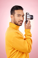 Image showing Portrait, man and retro camera for creative photography or taking a picture for art, travel or record of a memory. Serious, creative photographer and shooting on vintage film technology in studio