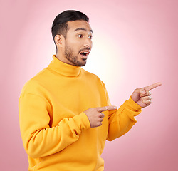 Image showing Surprise, pointing and wow with man and space in studio for show, announcement and deal. News, advertising and idea with person on pink background for promotion, information and solution mockup