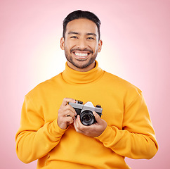 Image showing Portrait, photographer with a camera and smile for photography, taking picture for art or travel as cameraman with a happy memory. Creative man on studio background, shooting on retro or vintage film
