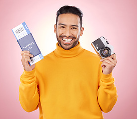 Image showing Happy asian man, portrait and passport with camera for travel or photography against a pink studio background. Male person or photographer smile with ticket for flight trip, photo or vacation memory