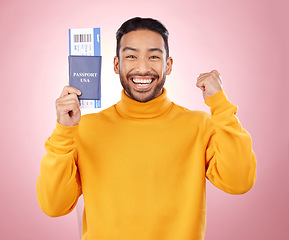 Image showing Happy asian man, portrait and passport with ticket for travel, winning or success against a pink studio background. Male person smile, documents or fist pump for flight discount, sale or holiday trip