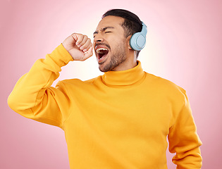 Image showing Asian man, headphones and listening to music for karaoke or singing against a pink studio background. Happy male person enjoying online audio streaming, sound track or songs with headset on mockup