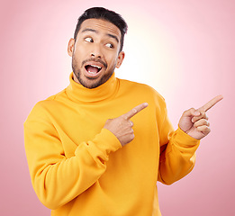 Image showing Pointing finger, advertising and a man in studio with a wow announcement, promotion or decision. Face of male asian model with hands for marketing sale, news or presentation on a pink background