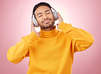 Image showing Happy, listening and man with headphones, music and stress relief against a studio background. Male person, audio and model with headset, streaming sounds and happiness with song, radio and podcast