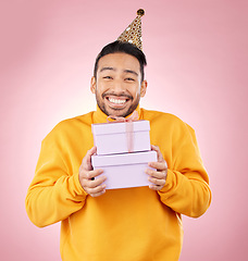 Image showing Man, portrait and gift box for birthday, prize and giveaway celebration or success on pink background. Excited asian person or winner with present for retail shopping, competition or sale in studio