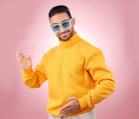 Image showing Man, robot dance and sunglasses in studio portrait with smile, moving or fashion for aesthetic by pink background. Asian gen z student, happy and clothes in futuristic glasses, comic dancing or party