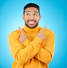 Image showing Smile, asian man and hand pointing to studio for news, deal or discount or how to guide on blue background. Happy, choice and male show timeline, checklist or direction, coming soon or sign up info