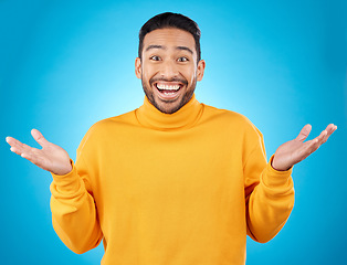 Image showing Wow, portrait and happy man in studio with hands for choice, decision or questions on blue background. Palm, scale and face of male customer excited, asking or why emoji for choosing, option or deal