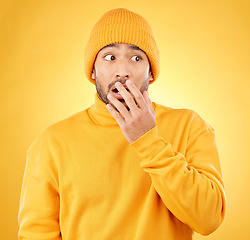 Image showing Surprise, hand and asian male shocked by winter, fashion and sale announcement in studio on yellow background. Wtf, worry and Japanese male customer with omg deal, news or coming soon promotion