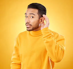 Image showing Gossip, whisper and man portrait with hand on ear in studio for speak up body language on yellow background. Secret, listen and face of guy with privacy, news or confidential coming soon promo