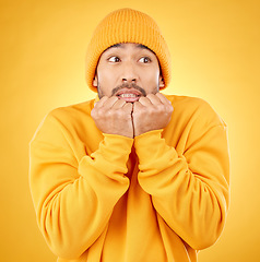 Image showing Surprise, face and asian male shocked by winter, fashion and sale announcement in studio on yellow background. Wtf, worry and Japanese male customer with omg deal, news or coming soon promotion