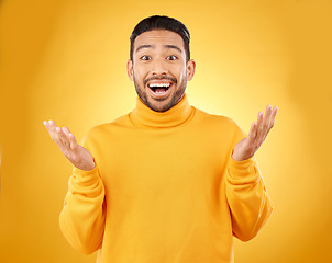 Image showing Excited, surprise and portrait of man with wow face, emoji or facial expression for joy isolated in a yellow studio background. Casual, happy and friendly young male person with smile reaction