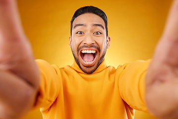 Image showing Excited, portrait and selfie of happy man in studio isolated on a yellow background. Face, smile and Asian person taking profile picture for funny memory, laughing and photography on social media