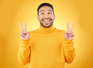 Image showing Peace, hands and happy asian man in studio with thank you, vote or feedback on yellow background. V, sign and Japanese male model with emoji fingers, smile and good mood, vibes or positive attitude