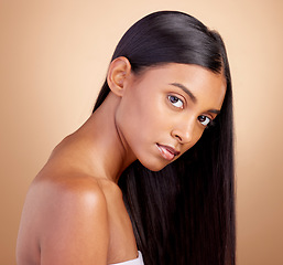 Image showing Portrait, hair care and Indian woman with beauty, cosmetics and dermatology on a brown studio background. Face, female person or model with volume, skincare and scalp treatment with beauty and luxury