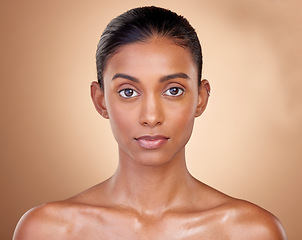 Image showing Portrait, skincare and woman with natural beauty, cosmetics and dermatology on a brown studio background. Face, female person or model with makeup, shine and glow with luxury, self care and aesthetic