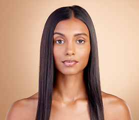 Image showing Portrait, hair care and Indian woman with beauty, cosmetics and dermatology on a brown studio background. Face, female person or model with volume, wellness or scalp treatment with aesthetic or shine