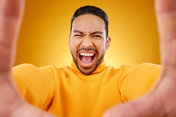 Image showing Screaming, portrait and selfie of angry man in studio isolated on a yellow background. Face, shouting and Asian person taking profile picture for memory in anger, frustrated or stress for problem