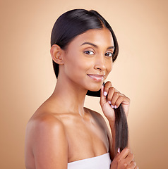 Image showing Portrait, hair care and Indian woman, with beauty, cosmetics and dermatology against a brown studio background. Face, female person or model with luxury, shine and glow with volume, growth or texture