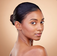 Image showing Portrait, skincare and woman with natural beauty, cosmetics and self care on a brown studio background. Face, female person and model with makeup, shine and glow with luxury, wellness and aesthetic