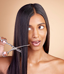 Image showing Cutting, hair care or Indian woman with scissors for beauty or self care for grooming on brown background. Transformation, studio or girl in salon with tools or cosmetics gear for haircut treatment