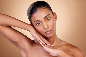 Image showing Beauty, portrait and indian girl for skincare with hands in brown studio background. Dermatology, face and spa treatment with self care or natural cosmetics in mock up for luxury facial or wellness.