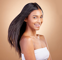 Image showing Hairstyle, salon and beauty with indian woman healthy shine in brown studio background. Haircare, girl and happy with wind for growth or keratin treatment with shine and natural cosmetic in mockup.