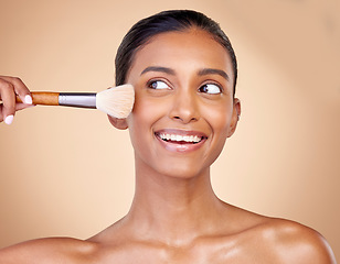 Image showing Beauty, makeup and smile with woman and brush in studio for facial, foundation and self care. Cosmetics, product and tools with face of model on brown background for glow, skincare and dermatology