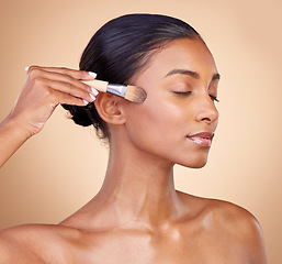 Image showing Beauty, makeup and cosmetics with woman and brush in studio for facial, foundation and self care. Relax, product and tools with face of model on brown background for glow, skincare and dermatology
