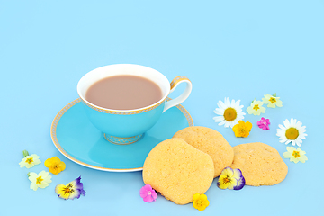 Image showing Afternoon Tea For One with Teacup Cookies and Spring Flowers