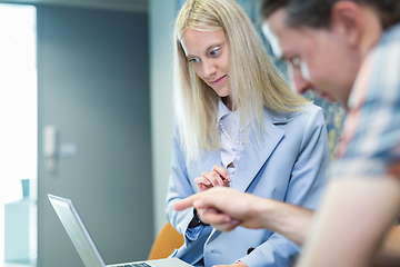 Image showing Business meeting. Client consulting. Confident business woman, real estate agent, financial advisor explaining details of project or financial product to client in office.