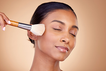 Image showing Beauty, makeup and relax with woman and brush in studio for facial, foundation and self care. Cosmetics, product and tools with face of model on brown background for glow, skincare and dermatology