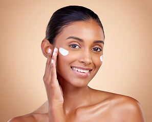 Image showing Face, cream and portrait of indian woman, skincare cosmetics and aesthetic dermatology on studio background. Happy young female model, lotion and facial sunscreen for clean beauty, glow and self care