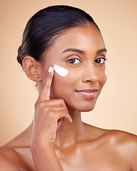 Image showing Face, beauty and woman, cream and cosmetics with skincare product on studio background. Indian female model in portrait, healthy glow and lotion on skin, dermatology and moisturizer with facial