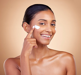 Image showing Face, cream and portrait of happy indian woman, makeup cosmetics and skincare dermatology on studio background. Young female model, lotion and facial sunscreen for clean beauty, shine and self care