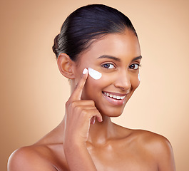 Image showing Face, cream cosmetics and portrait of happy woman for aesthetic shine, skincare or dermatology on studio background. Indian female model, lotion or facial product for clean beauty, glow and self care