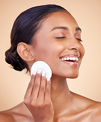 Image showing Happy woman, cotton pad and skincare of face cosmetics, aesthetic wellness and studio background. Indian female model, clean beauty and facial cleaning product for makeup removal, dermatology or glow