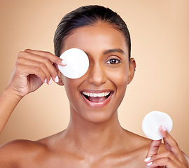 Image showing Happy woman, cotton pad and skincare for eyes, face or aesthetic cosmetics on studio background. Portrait of indian female model, beauty and facial product for makeup, toner wipe or clean dermatology